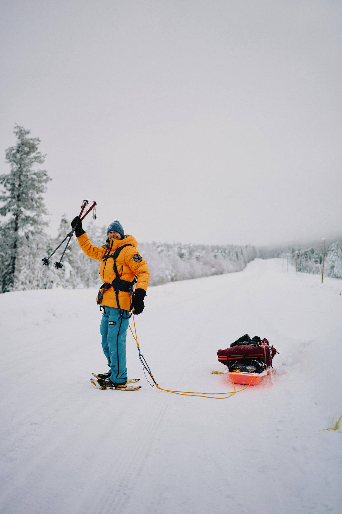 Pawel Dregan hauling a sled across a frozen Lapland snowfield
